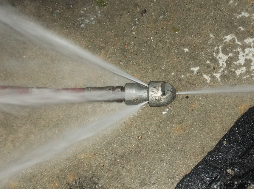High-efficiency jetting nozzle sprays water to clean sewer lines